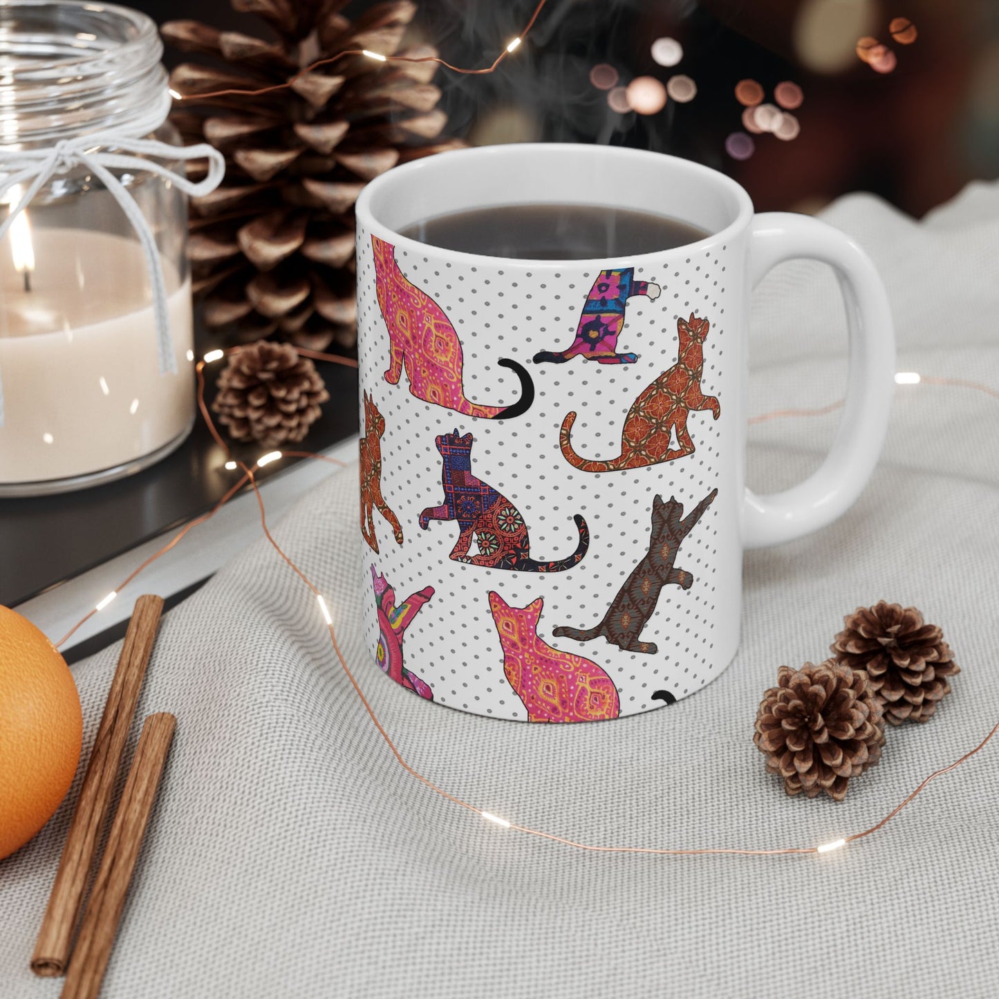 White mug with colorful cat pattern. 