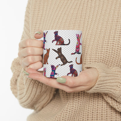 White mug with colorful cat pattern. 