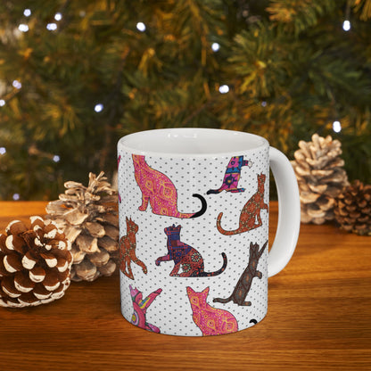 White mug with colorful cat pattern. 