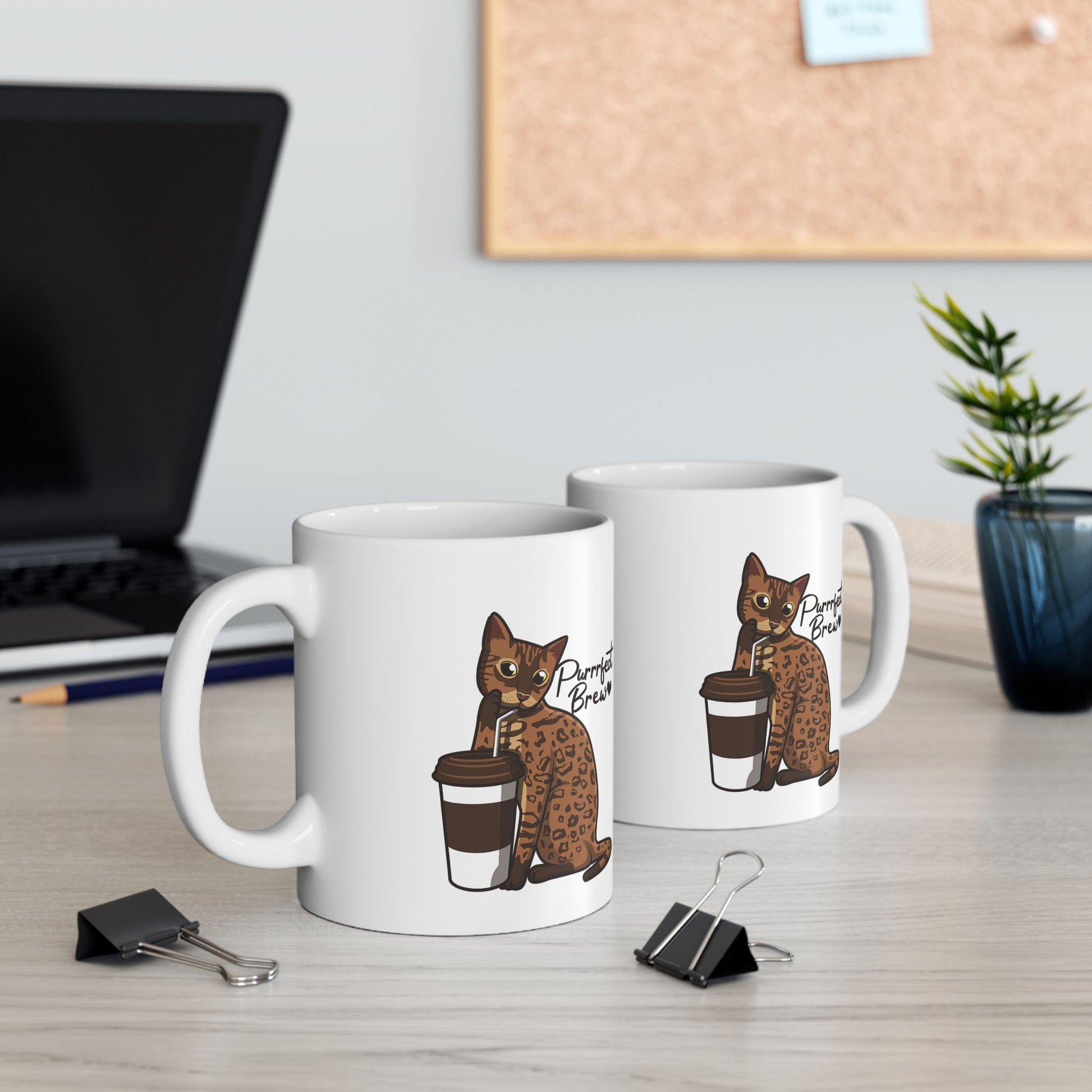 White mug with illustration of a Bengal Cat posing with a coffee cup and text 'Purfect Brew'  