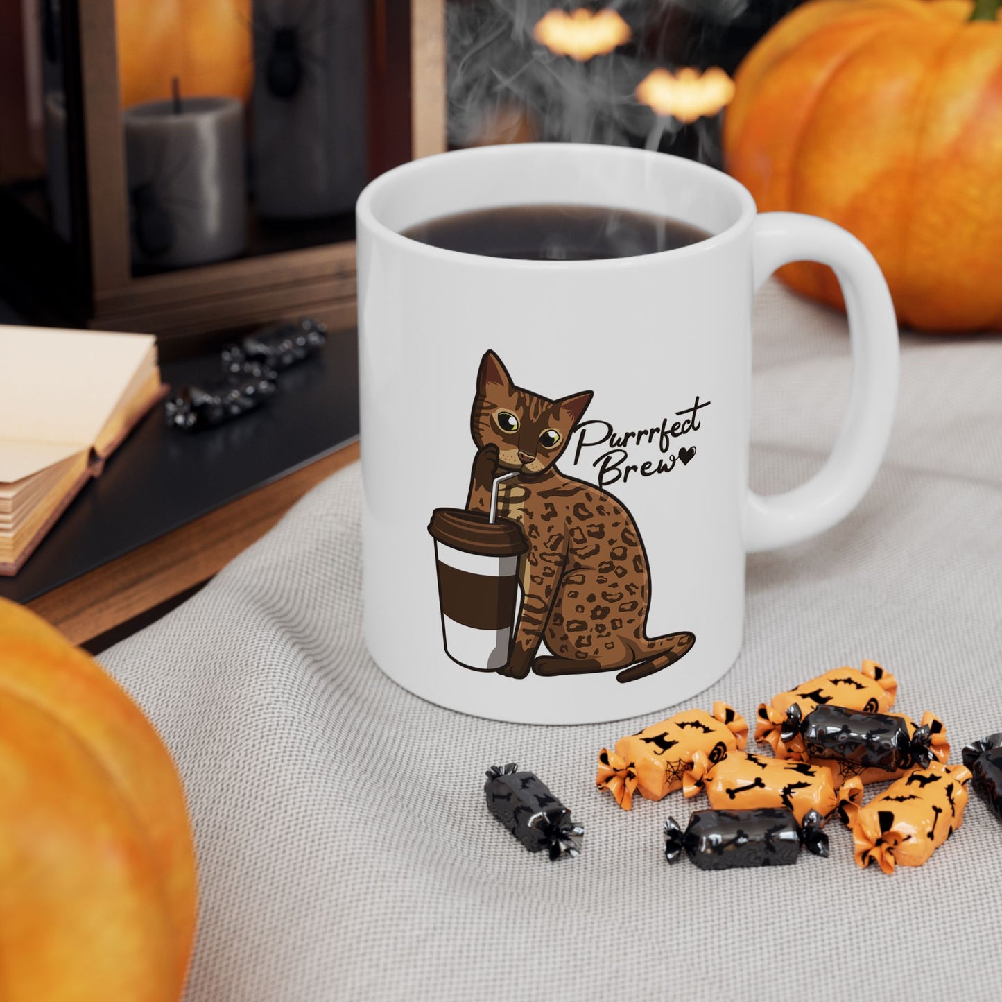 White mug with illustration of a Bengal Cat posing with a coffee cup and text 'Purfect Brew'  
