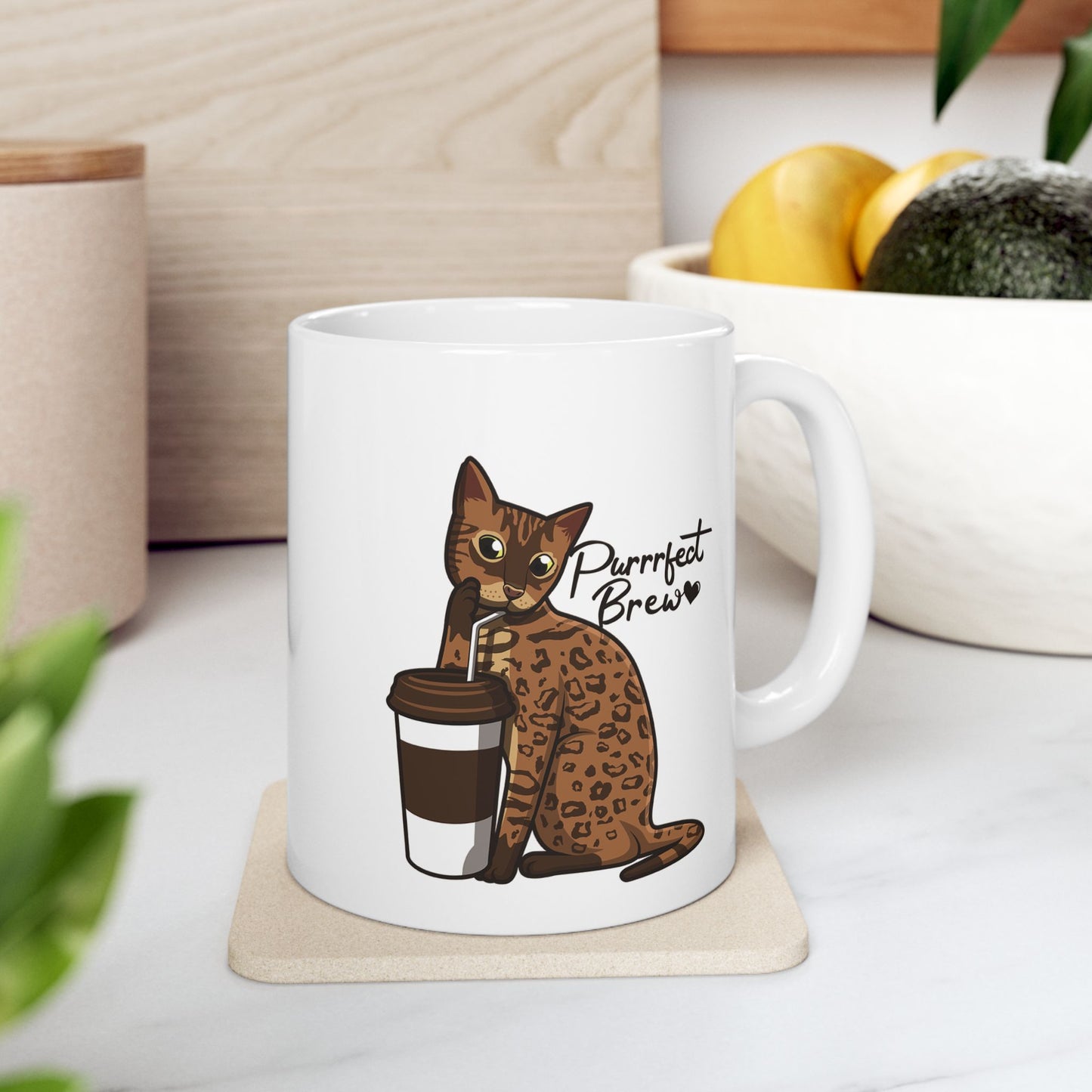 White mug with illustration of a Bengal Cat posing with a coffee cup and text 'Purrrfect Brew.'  
