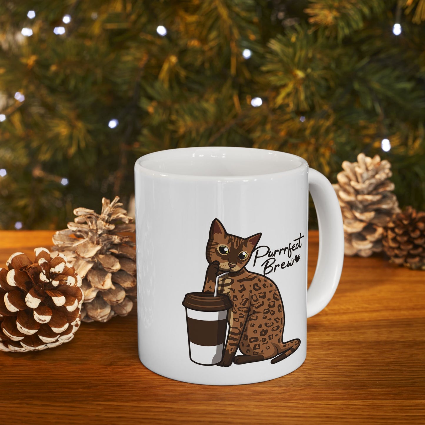 White mug with illustration of a Bengal Cat posing with a coffee cup and text 'Purrrfect Brew.'  