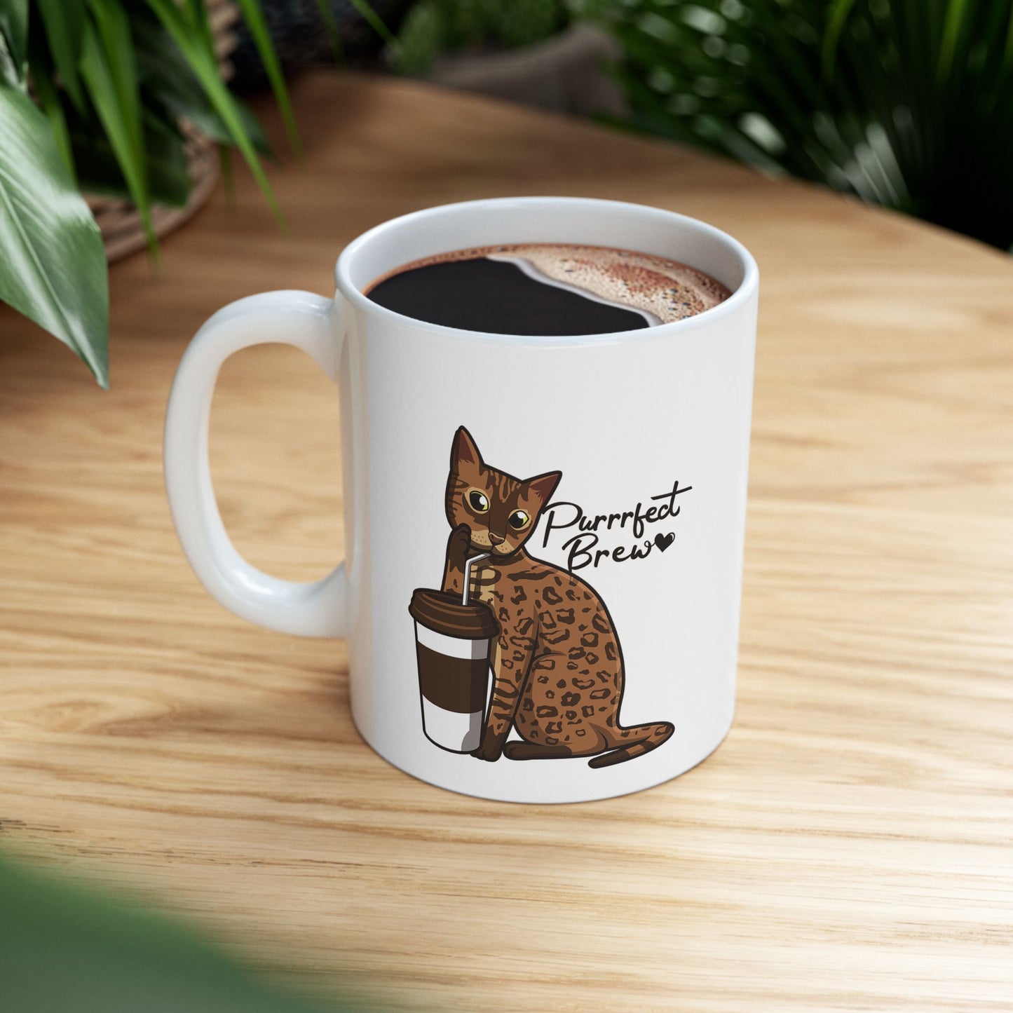 White mug with illustration of a Bengal Cat posing with a coffee cup and text 'Purrrfect Brew.'  