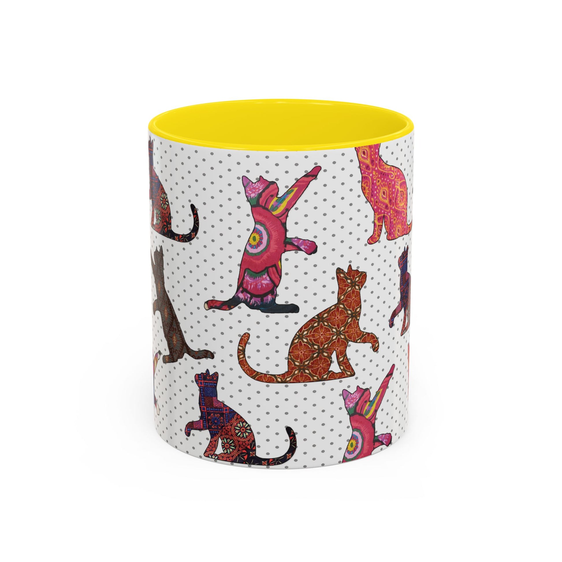 Yellow mug with colorful cat silhouette pattern.