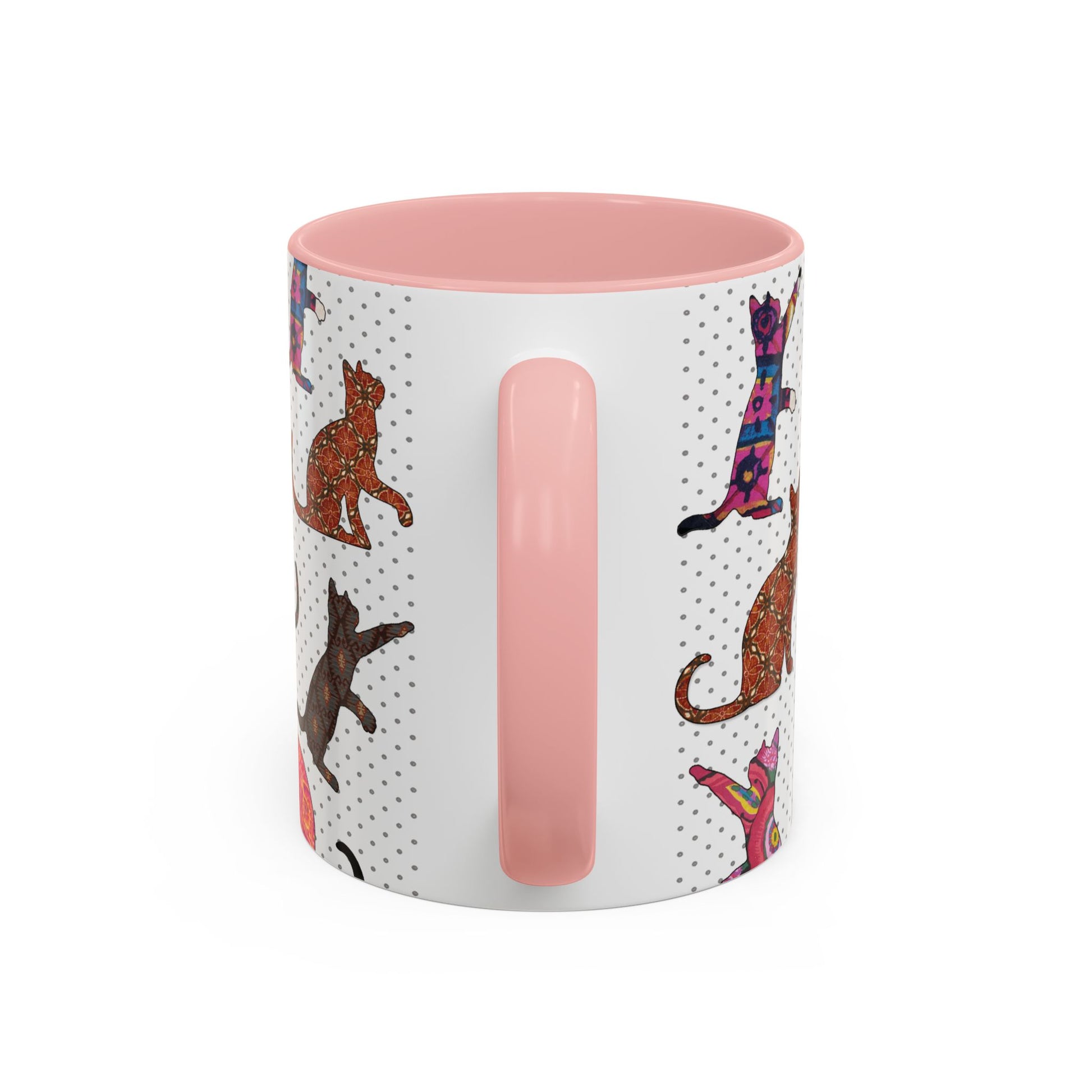 Pink mug with colorful cat silhouette pattern.
