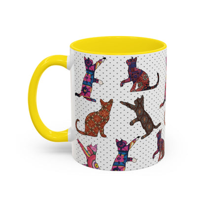 Yellow mug with colorful cat silhouette pattern.