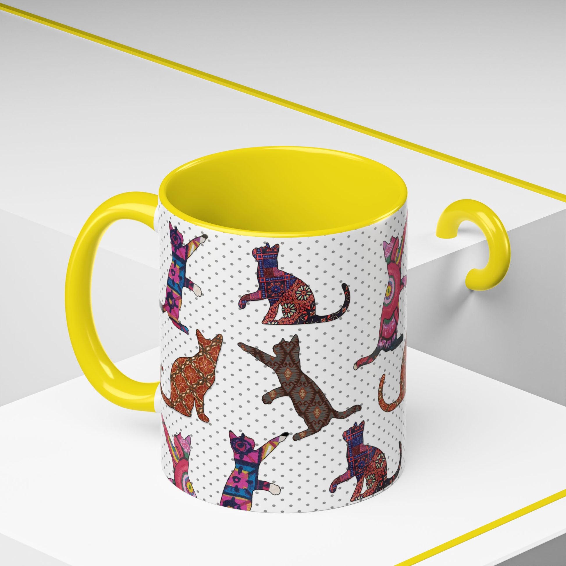 Yellow mug with colorful cat silhouette pattern.