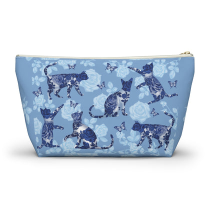 A floral blue accessory bag with a pattern of kitty silhouettes, roses, and butterflies, featuring a zipper closure. Cosmetic, makeup, toiletry, travel, pencil case & everyday essentials bag for cat lovers.