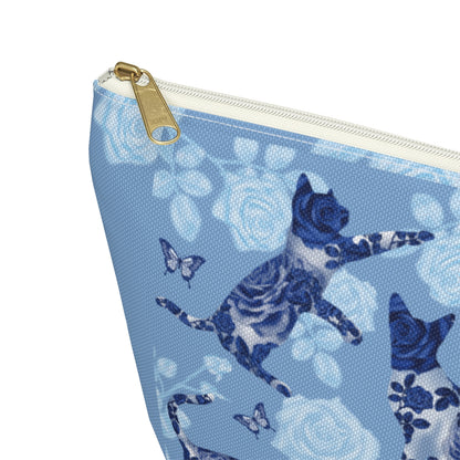 A floral blue accessory bag with a pattern of kitty silhouettes, roses, and butterflies, featuring a zipper closure. Cosmetic, makeup, toiletry, travel, pencil case & everyday essentials bag for cat lovers.