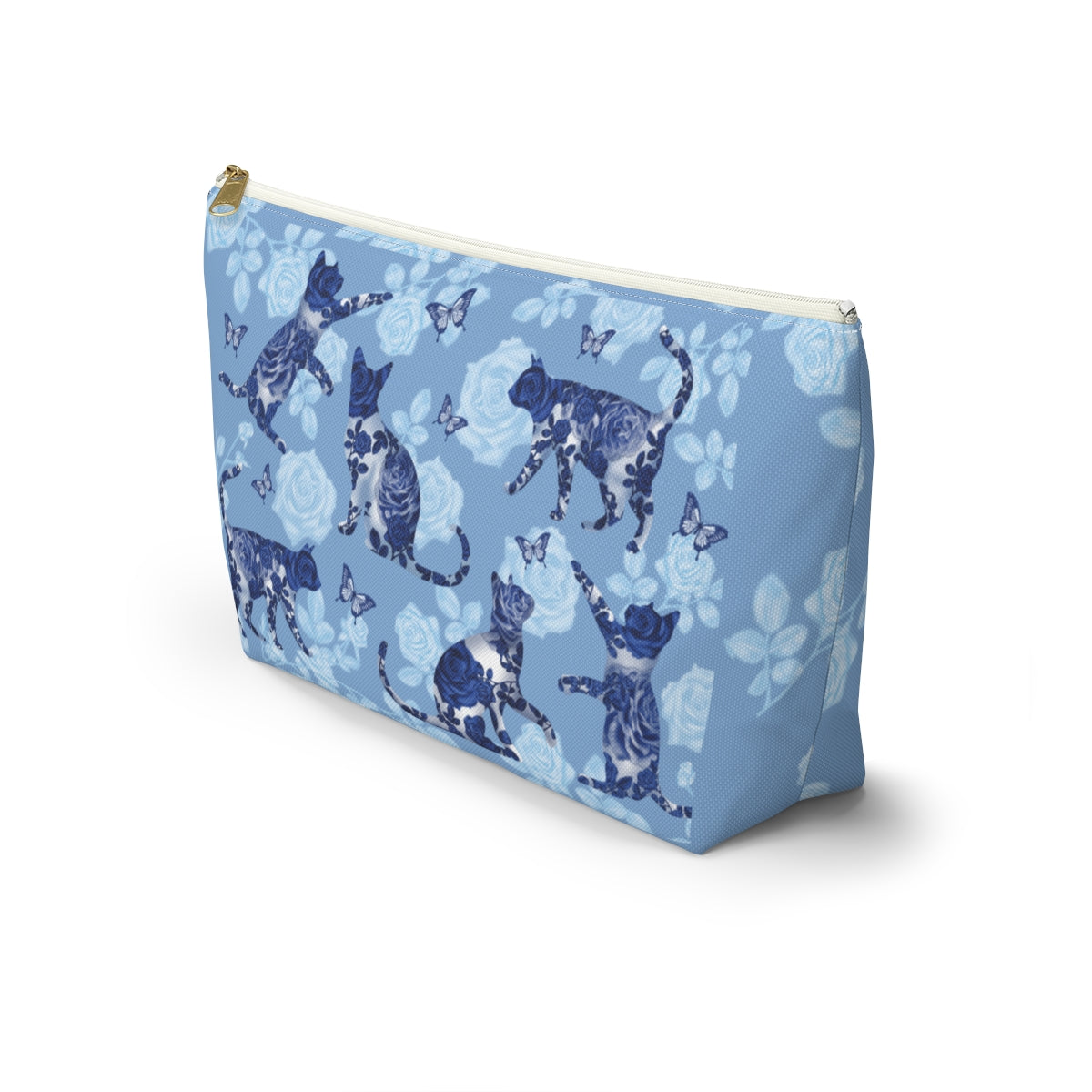 A floral blue accessory bag with a pattern of kitty silhouettes, roses, and butterflies, featuring a zipper closure. Cosmetic, makeup, toiletry, travel, pencil case & everyday essentials bag for cat lovers.