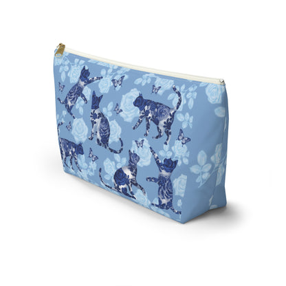 A floral blue accessory bag with a pattern of kitty silhouettes, roses, and butterflies, featuring a zipper closure. Cosmetic, makeup, toiletry, travel, pencil case & everyday essentials bag for cat lovers.