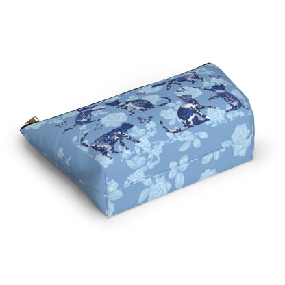 A floral blue accessory bag with a pattern of kitty silhouettes, roses, and butterflies, featuring a zipper closure. Cosmetic, makeup, toiletry, travel, pencil case & everyday essentials bag for cat lovers.