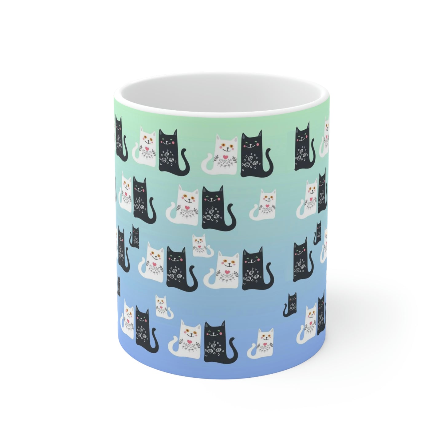 Mug with a pattern of black and white cartoon cats.