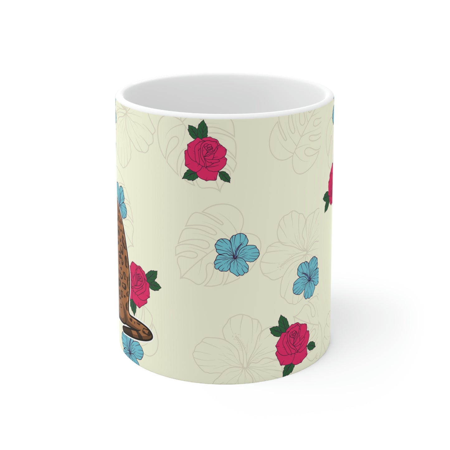 Cream mug of a cartoon Bengal cat drinking from a cup against a floral background