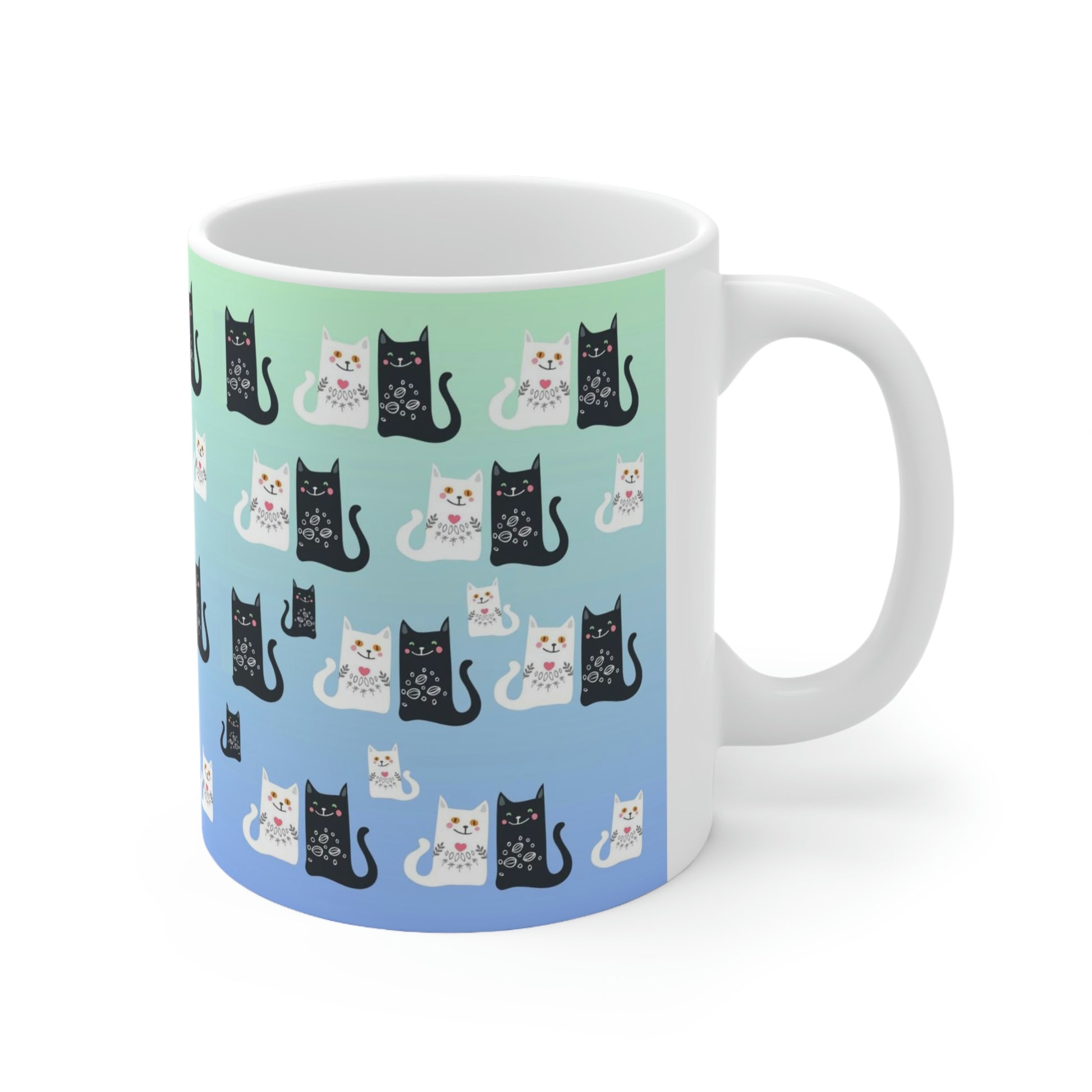 Mug with a pattern of black and white cartoon cats.